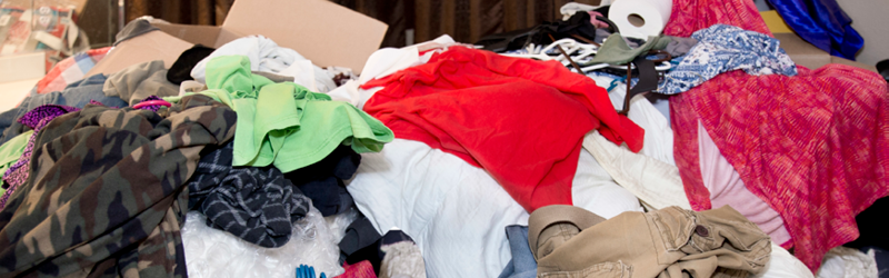 Large pile of unfolded clothing