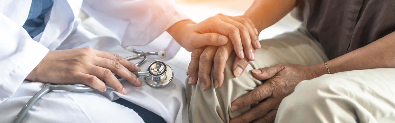 Hand of a doctor holding patient hand comforting them